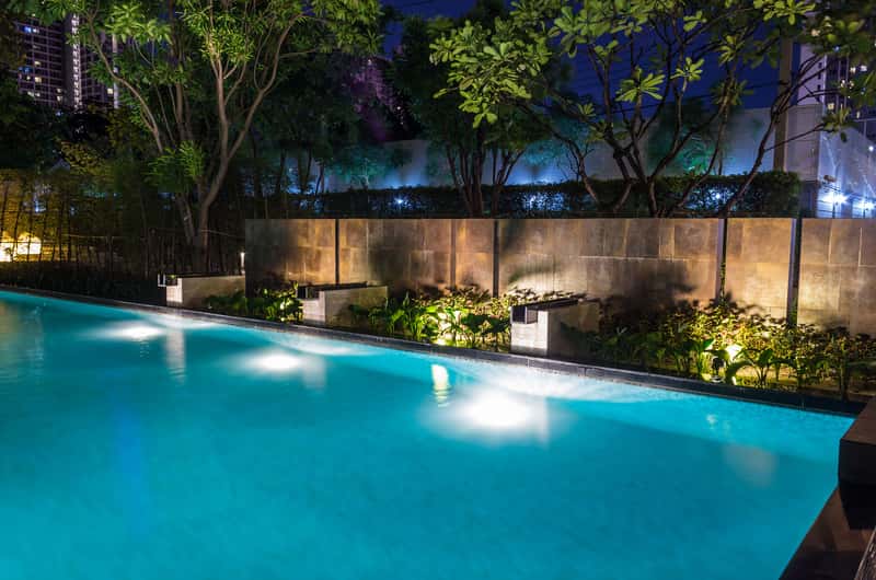 in ground pool illuminated with solar lights